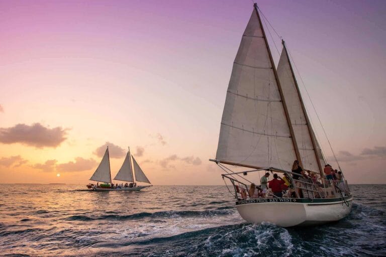 group of friends enjoying a fun sailing adventure on the deck of a sailboat, surrounded by clear blue sea waters