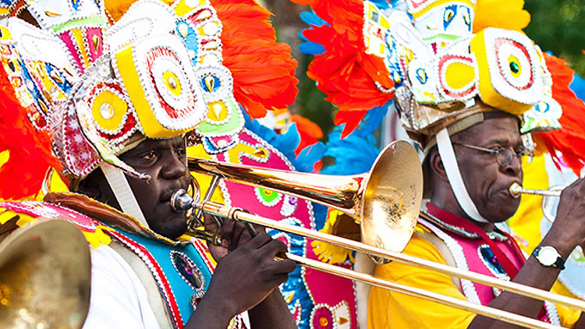 Colorful Caribbean festival with musicians in vibrant costumes playing brass instruments, showcasing lively cultural celebrations in Key West.