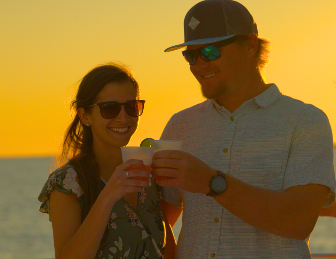 A couple with cocktails on a key west sunset sail